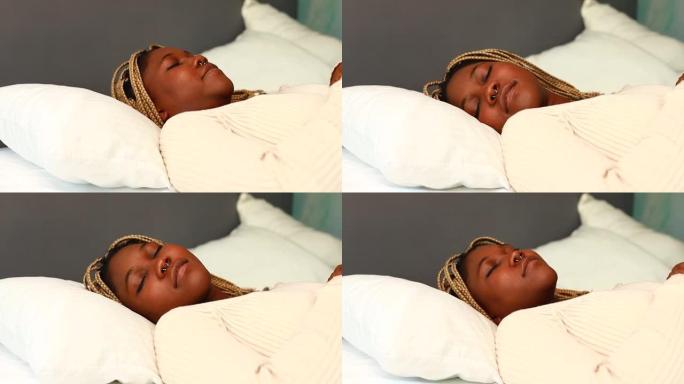 非裔美国妇女试图入睡但枕头不舒服