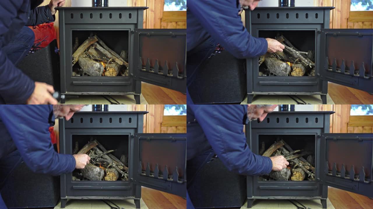 男子在质朴的铸铁炉子里点燃火来加热房子。