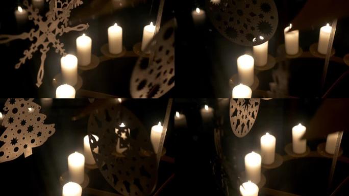 降临节白色蜡烛上的旋转装饰由胶合板制成，描绘天使或圣诞树11