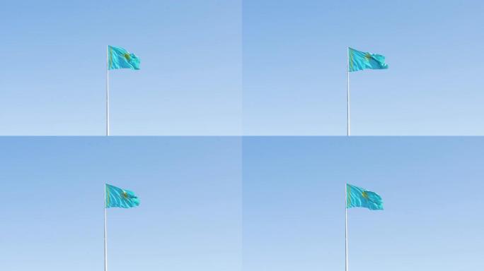 在阳光明媚的日子里，哈萨克斯坦国旗迎风飘扬。在哈萨克斯坦的蓝天下，旗杆上挥舞着国旗
