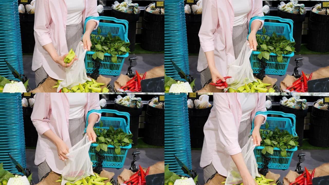 女人在当地生态市场上从货架上选择新鲜蔬菜的电影镜头。当地农民种植的新鲜蔬菜农产品交易会。有机蔬菜种植