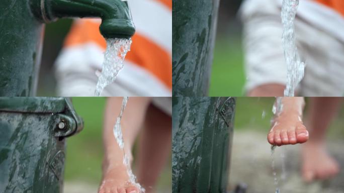 孩子在外面的水龙头洗脚。儿童在公园户外清洁身体的脚