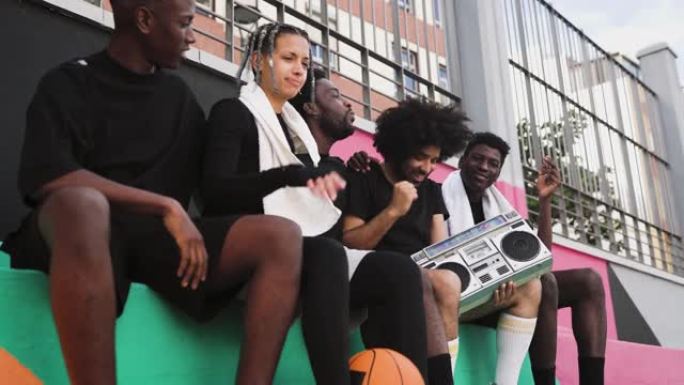 年轻的非洲裔美国人享受着老式音箱户外音乐的乐趣 -- 城市街头人的生活方式