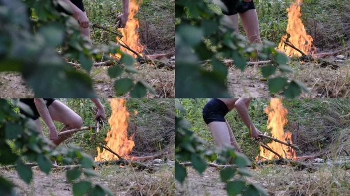 夏天，一个男人在森林里篝火，同时在大自然中放松身心