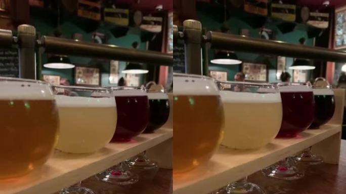 各种五颜六色的啤酒放在桌子上。垂直镜头高清
