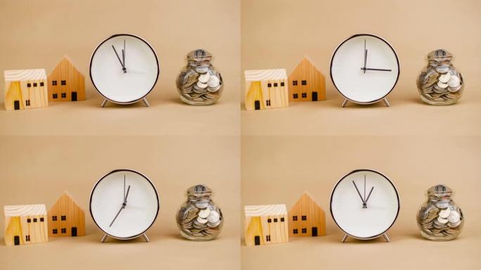 闹钟。白色快速转动时间概念，木屋和储蓄。