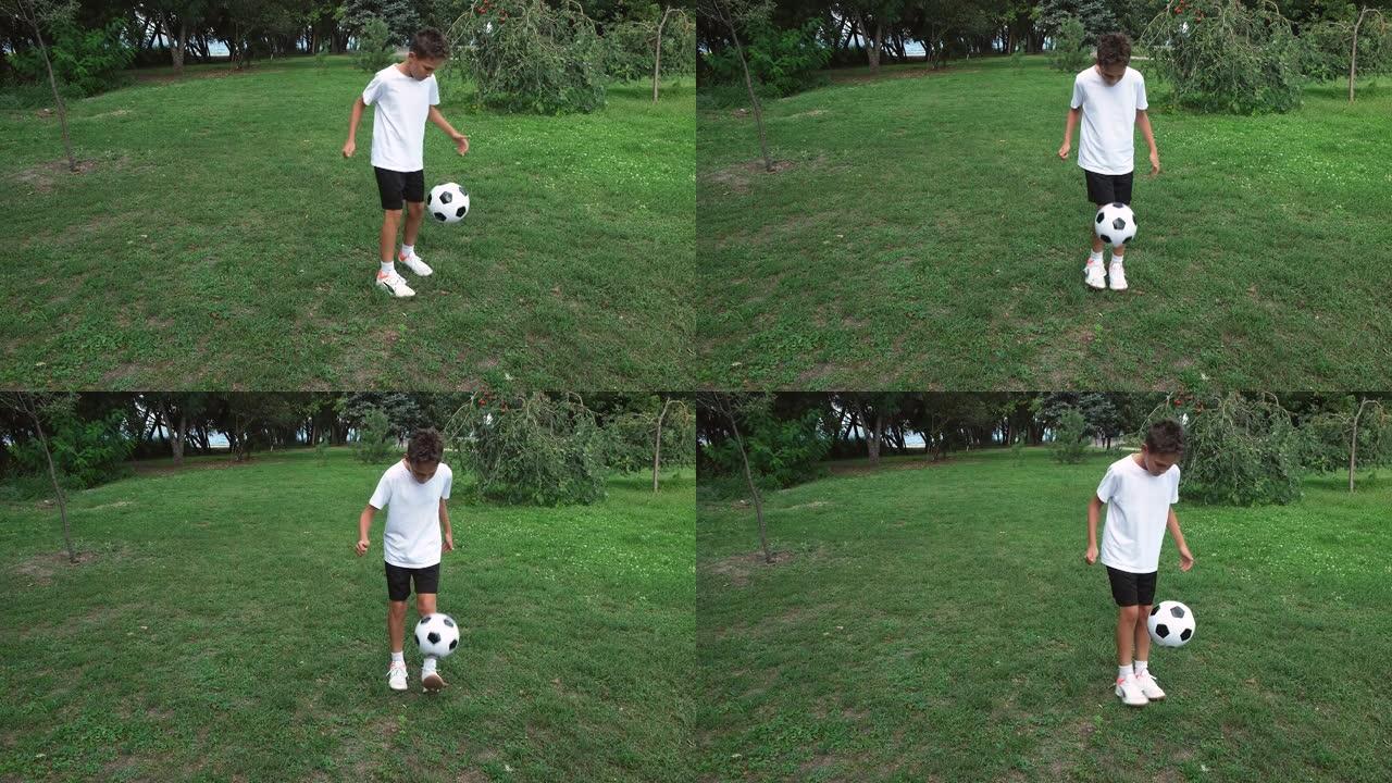十几岁的男孩在户外踢足球，夏天在公园踢球。