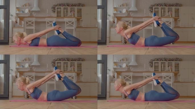 积极运动适合灵活的成熟女性在家瑜伽弓姿势伸展