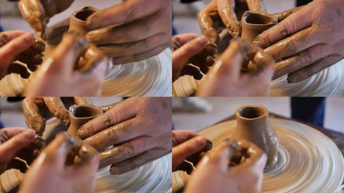 陶工大师的男性手在旋转的陶工轮上创造了粘土kushin的形状，同时在培训车间向十几岁的孩子教授陶艺课