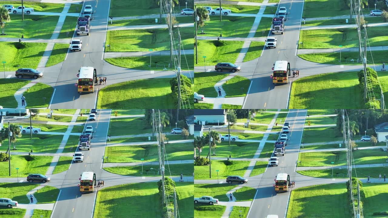 清晨，美国黄色校车在人行道上接孩子的鸟瞰图。美国的公共交通