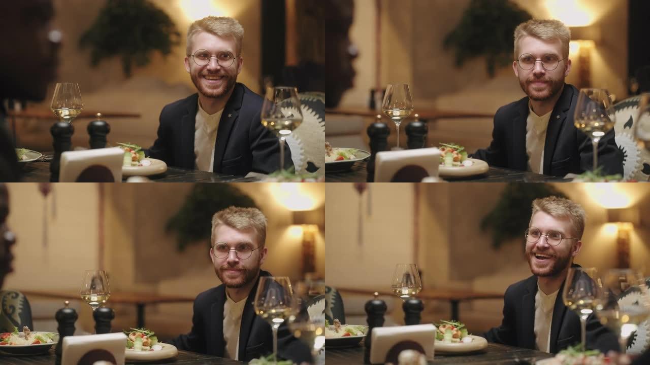 男人在餐厅玩得开心，与朋友或家人一起用餐，英俊的白人肖像
