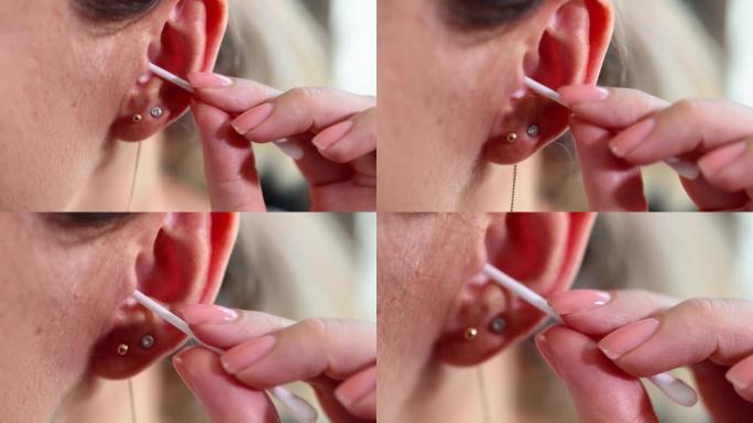女人用硫磺特写4k电影慢动作的棉签清洁耳朵