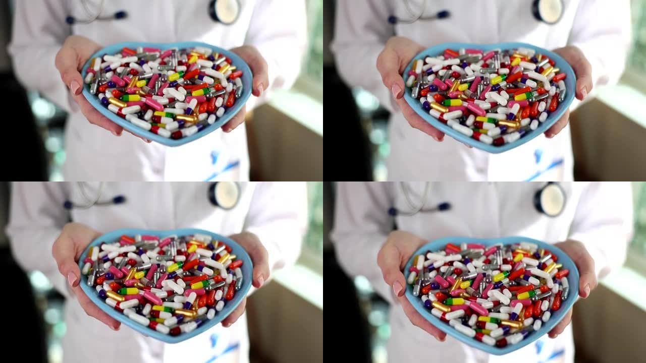 医生手握心脏形状的盘子与许多医用胶囊特写4k电影慢动作