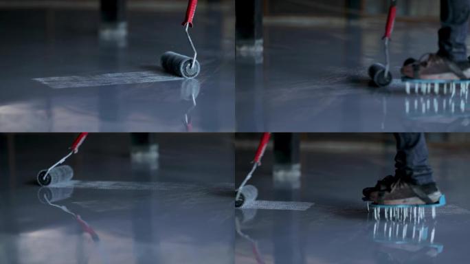 自流平地板上的滚针。自流平地板工具。自流平树脂环氧。用环氧树脂地板的混合物调平