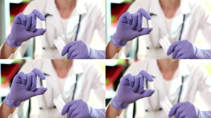 戴手套的医生持有肛门或阴道使用的栓剂
