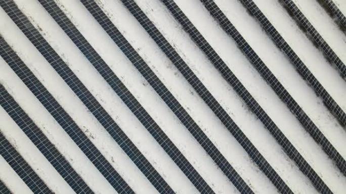 发电厂的鸟瞰图，太阳能电池板覆盖着积雪，在冬季结束时融化以产生清洁能源。北部地区可再生电力低效概念