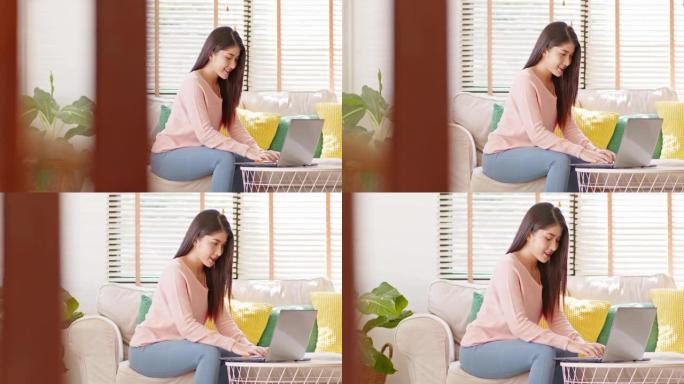 企业家美丽的商业亚洲年轻女子穿着粉色毛衣在家用笔记本电脑在线工作。自由女性在线销售营销，在家在线购物