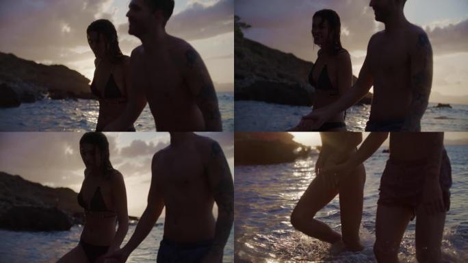 浪漫的异性恋夫妇在日落时一起在海里游泳。牵着手走回沙滩