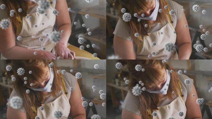 在陶器工作室工作的妇女戴着口罩的covid 19细胞动画