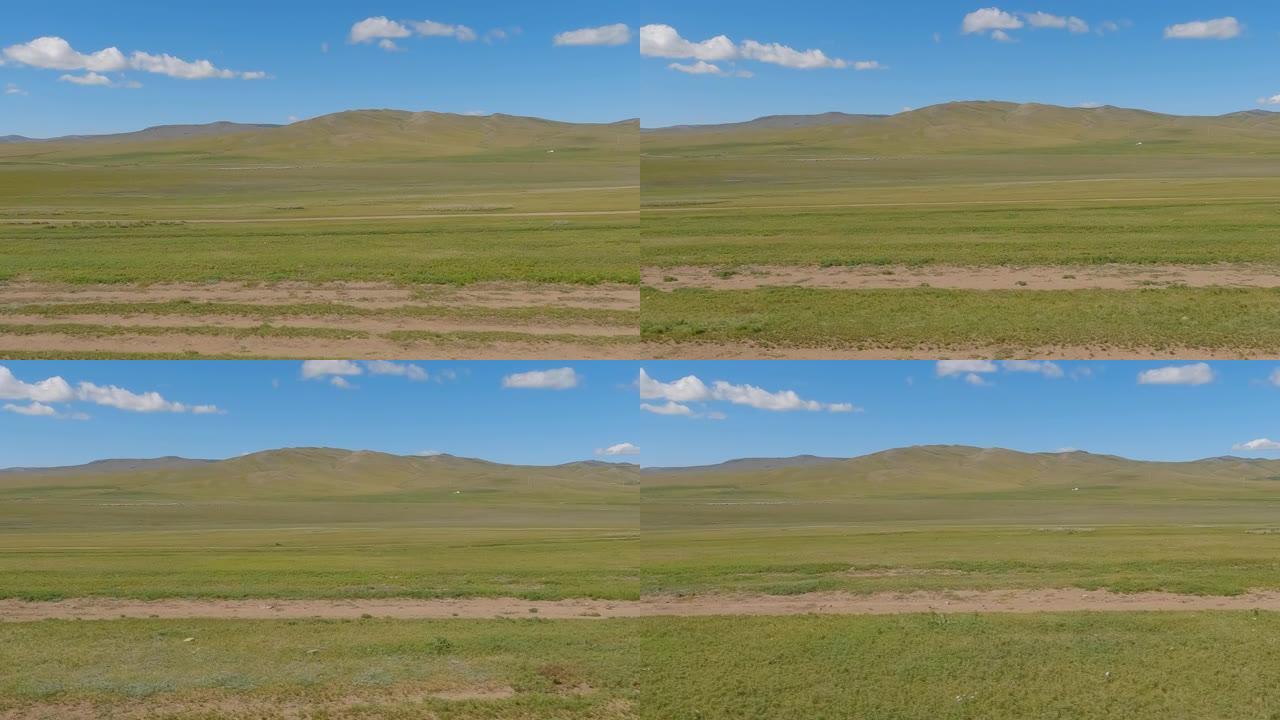 穿越开阔的草原和雄伟的蒙古山脉。乡村山水有山，蓝天有云。