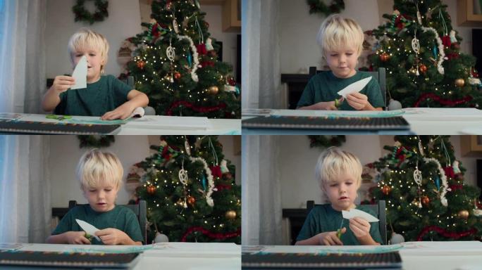 可爱的儿童男孩剪纸手工圣诞礼物用剪刀