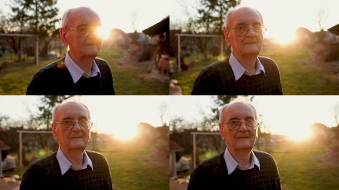 沉思的高加索老人的肖像，在日落时的大自然中