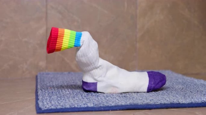 一只袜子站在地毯上浴室的地板上。缺少一双袜子。