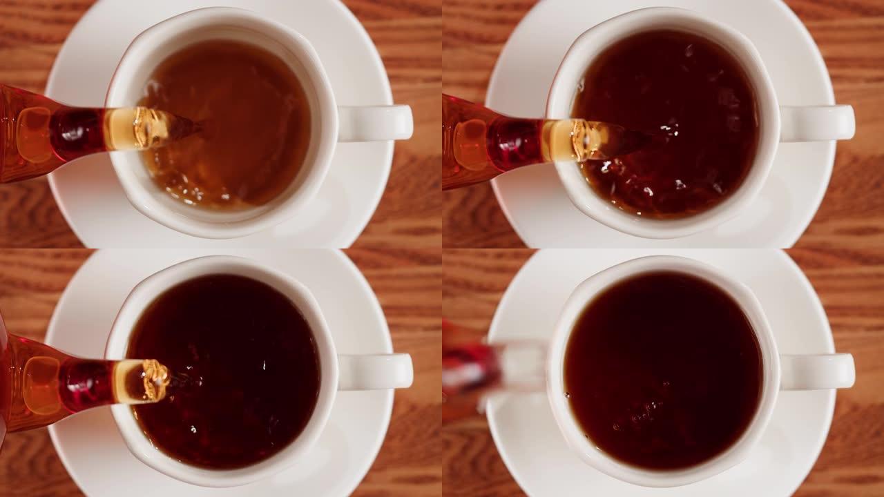 将红茶倒入杯中。新鲜冲泡的绿茶仪式过程，健康的早晨，排毒饮料。