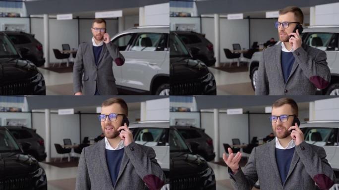 戴着眼镜和西装的白人男子来到镜头前，在汽车经销店通过电话讲话