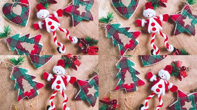 圣诞背景与玩具圣诞老人，新年树，树枝，树枝，和明星。新年装饰品在棕色粗麻布背景上旋转。平躺，俯视图。