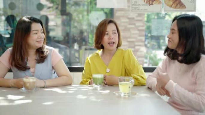 一群中年亚洲女性朋友在咖啡馆里玩得开心聊天，老年观念，朋友，幸福