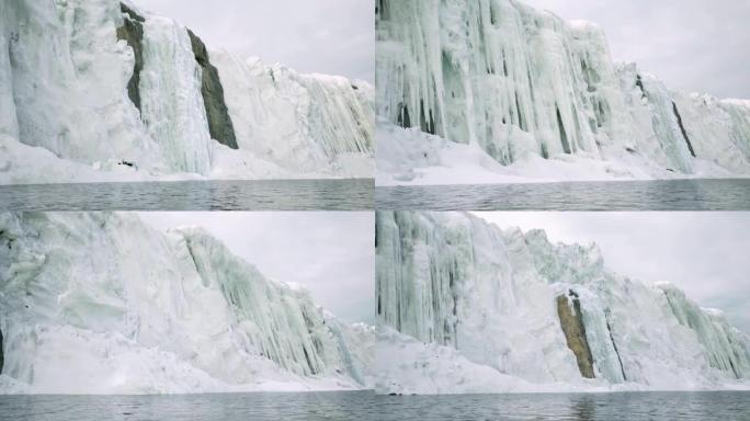 由于气候变化导致的温度升高，高山悬崖上冰雪融化的特写镜头