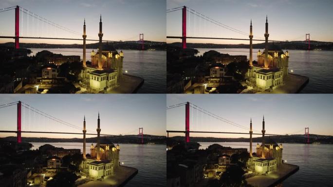 土耳其伊斯坦布尔奥塔科伊。伊斯坦布尔的鸟瞰图。奥塔科伊清真寺和博斯普鲁斯大桥日出景观。全景无人机拍摄
