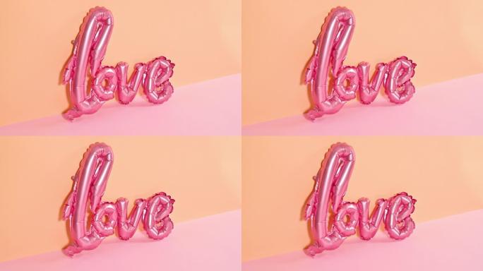 爱情浪漫情人节气球出现在橙色粉色柔和主题上。停止运动