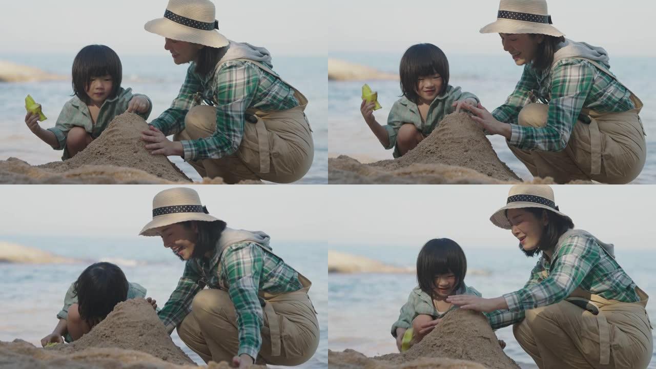 亚洲母子在沙滩上玩得开心。
