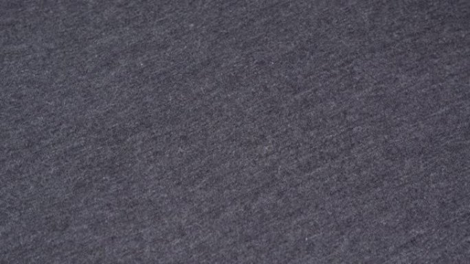 细节浅灰色纹理织物，纺织品，材料，特写，宏观。灰色织物背景。浅灰色纤维。纺织厂