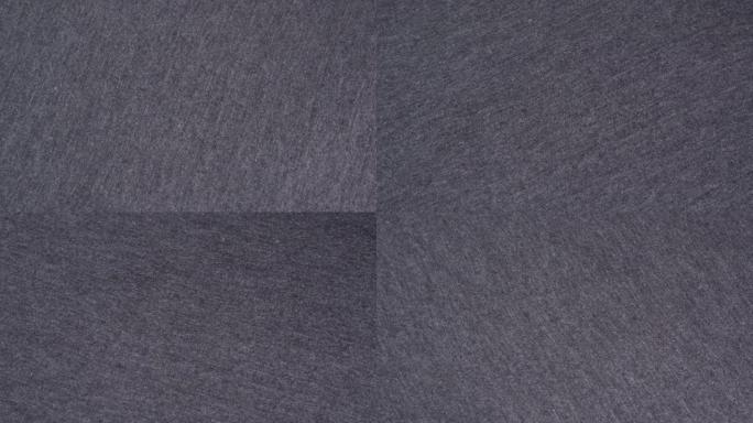 细节浅灰色纹理织物，纺织品，材料，特写，宏观。灰色织物背景。浅灰色纤维。纺织厂