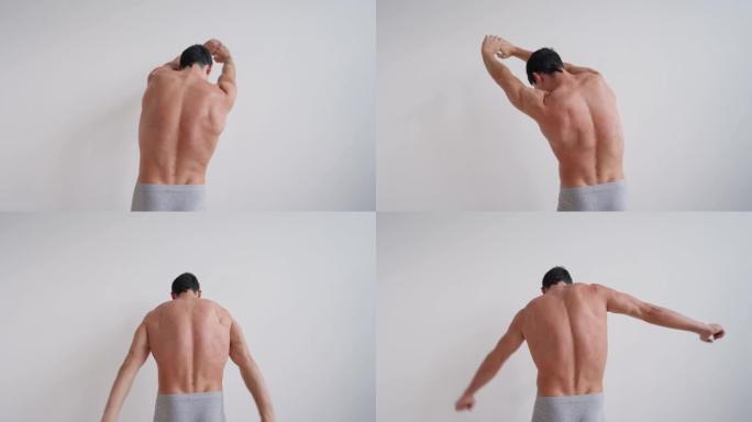 运动裸男伸展他的背部感到疼痛和不适