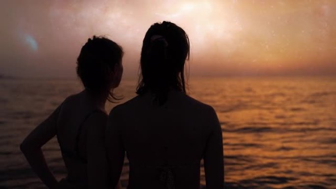 两个女人在一个星球上看着旋转的等离子太阳。照亮金海