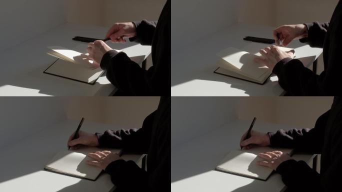 男子打开日记并开始用笔写文字的实时镜头