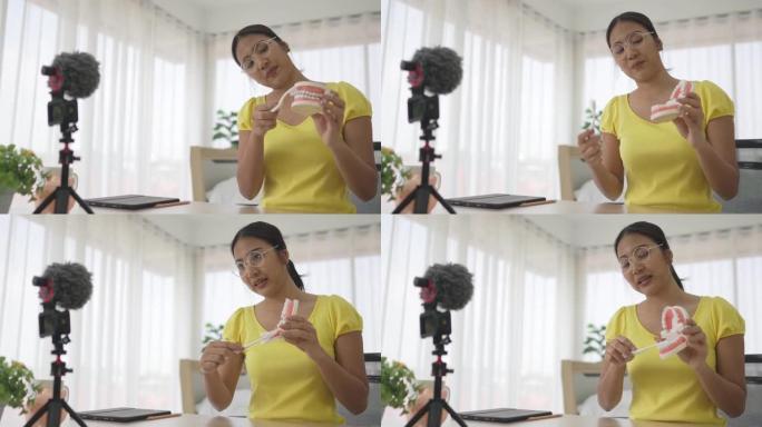 亚洲女教师折纸日本折纸风格，使用相机和笔记本电脑在线教学。