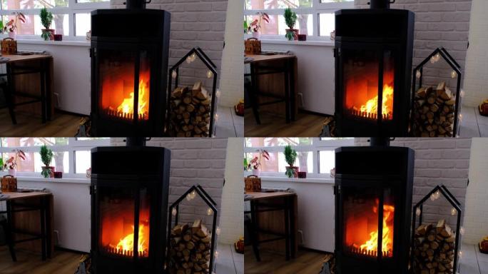 房子的节日内部以阁楼风格为圣诞节和新年装饰，配有黑色炉子、壁炉、圣诞树。温暖的工作室，配有白色厨房、