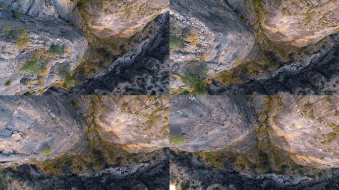 山间河流的俯视图。多岩石的海岸。无人机拍摄的视频。岩石上的绿色灌木。从悬崖上掉下来