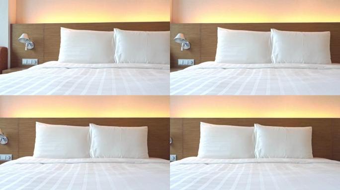 标准酒店客房卧室，配有白色床单和枕头的睡床，平底锅