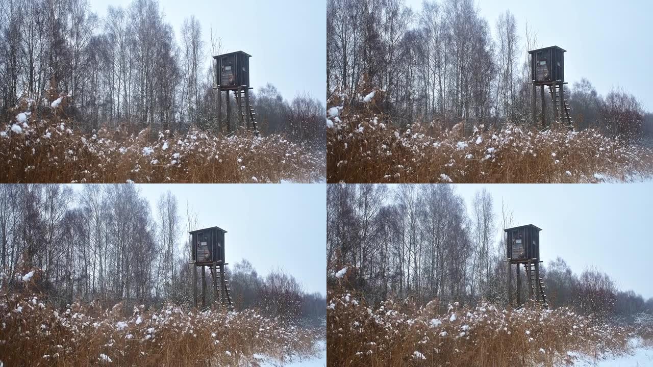 猎人在秋天或冬天下雪的情况下在立陶宛乡村的森林中狩猎的木制小屋