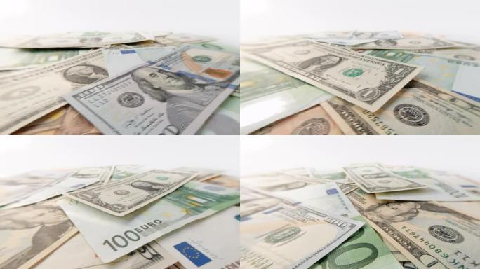 各种面额的美元和欧元的旋转纸币特写。美元与欧元轮换的背景。4k宏原始视频60 fps。