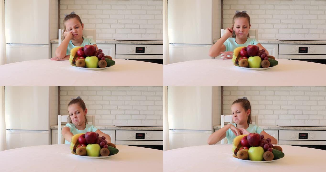 不开心的孩子坐在早餐时。孩子不想吃蔬菜水果