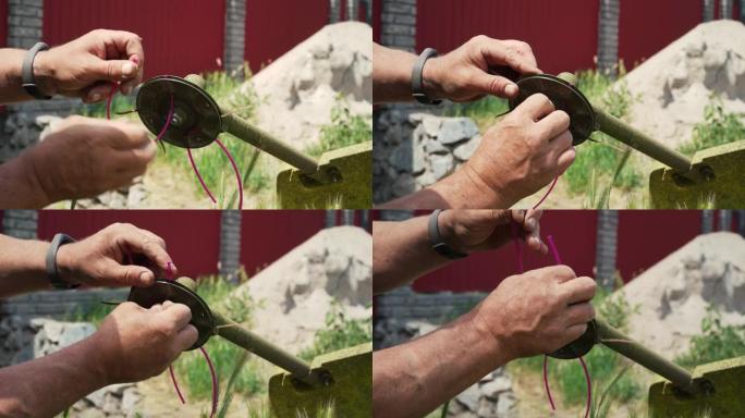 一个男人的手拆开割草机更换零件的特写镜头。通过更换零件来维护和修理除草器。