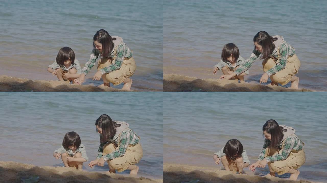 亚洲母子在沙滩上玩得开心。
