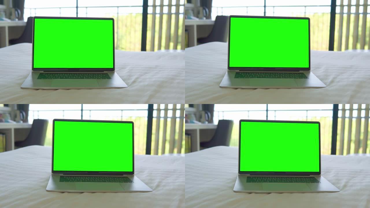 笔记本电脑在家里的床上显示绿屏。